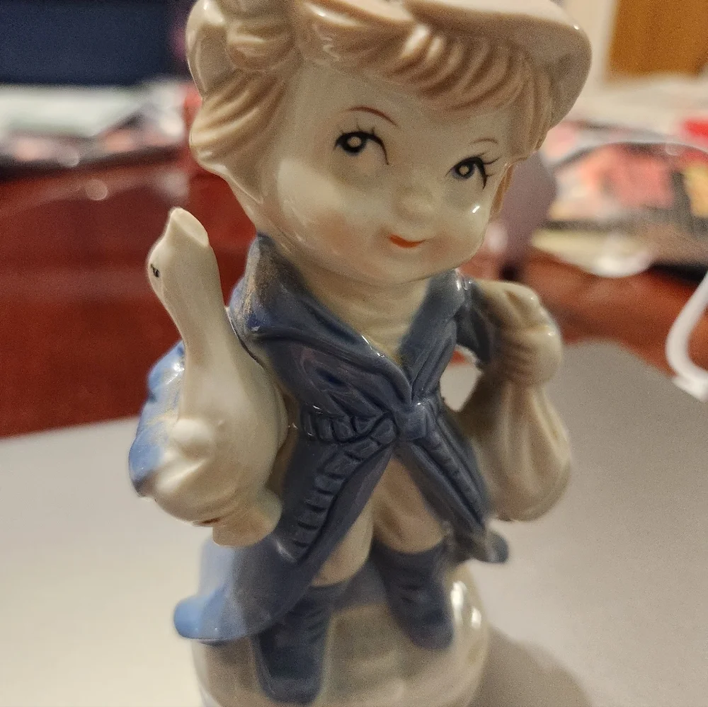 KPM Porcelain Child Figurine Holding Duck And Bag  2H”x3L”